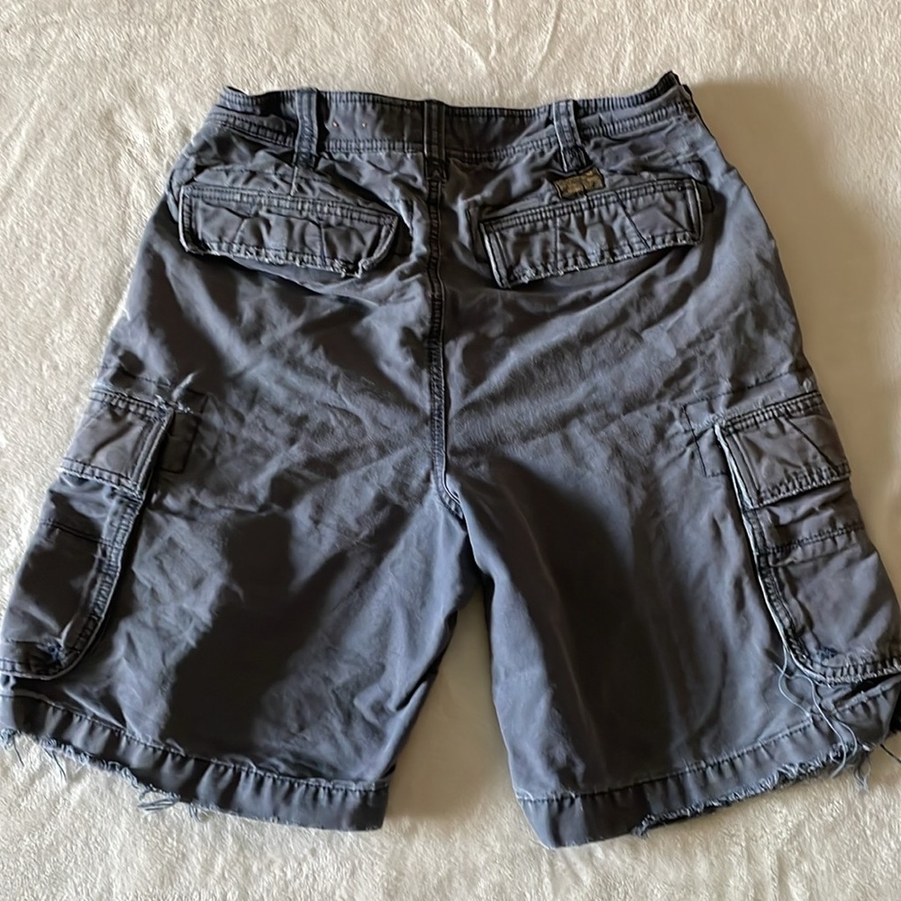 Men’s cargo short.Used with feathered threads aesthetic at the bottom. Blue/Gray